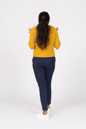 Rear view of a girl in casual clothes