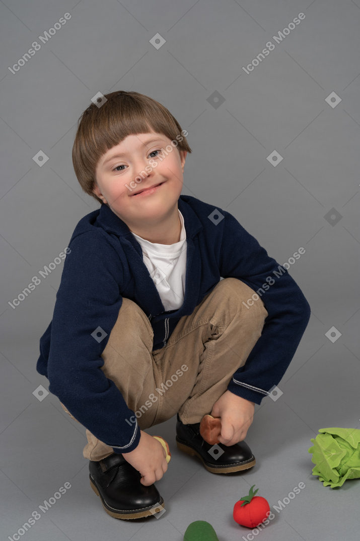 Portrait of a little boy playing with stuffed vegetables