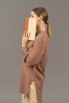 Woman covering her face in profile