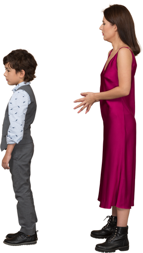 Young woman in red dress and boy standing still