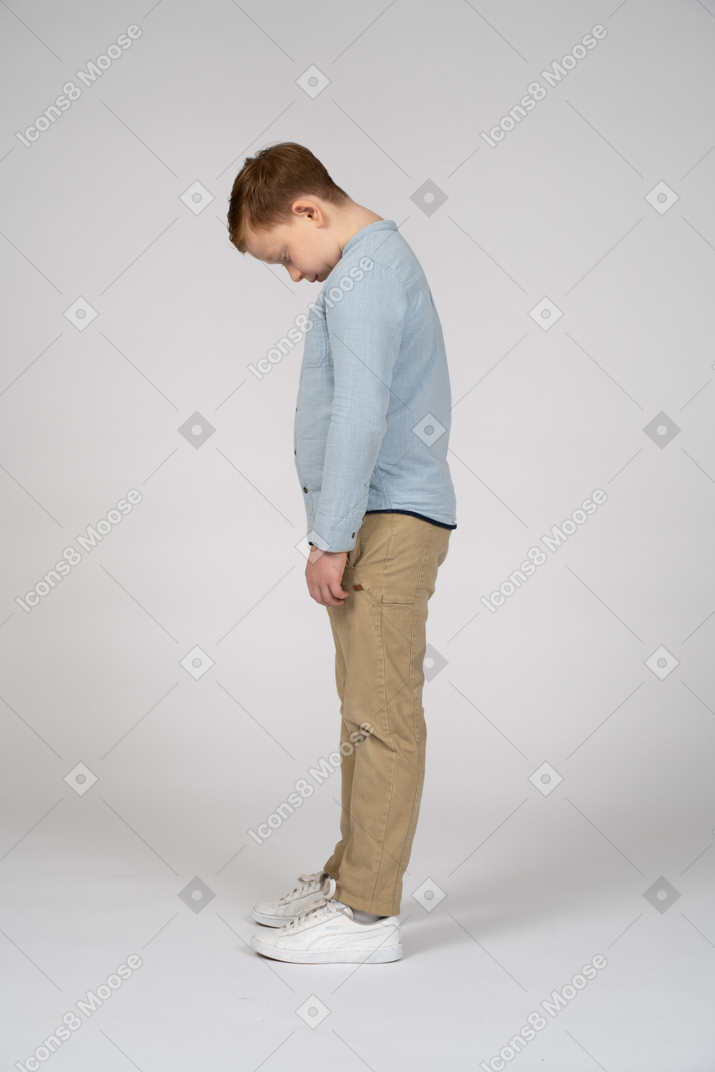 Side view of a boy bending head down