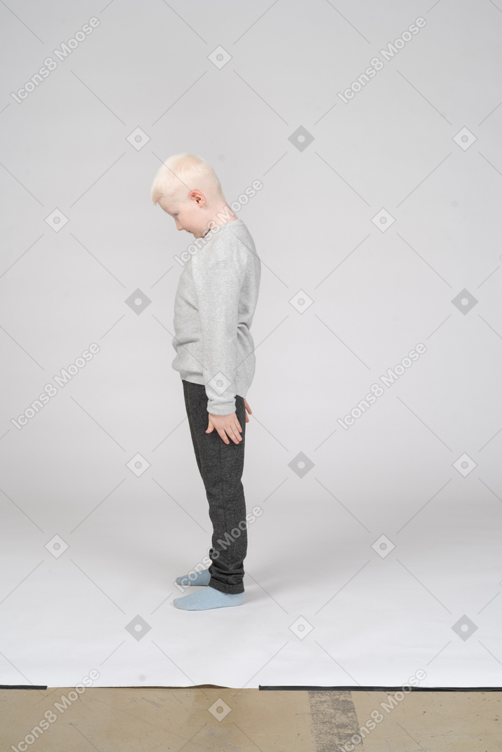 Side view of a boy with his head down