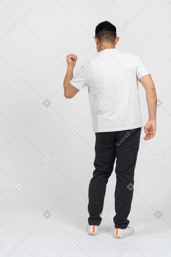一个穿着休闲服的男人展示拳头的后视图