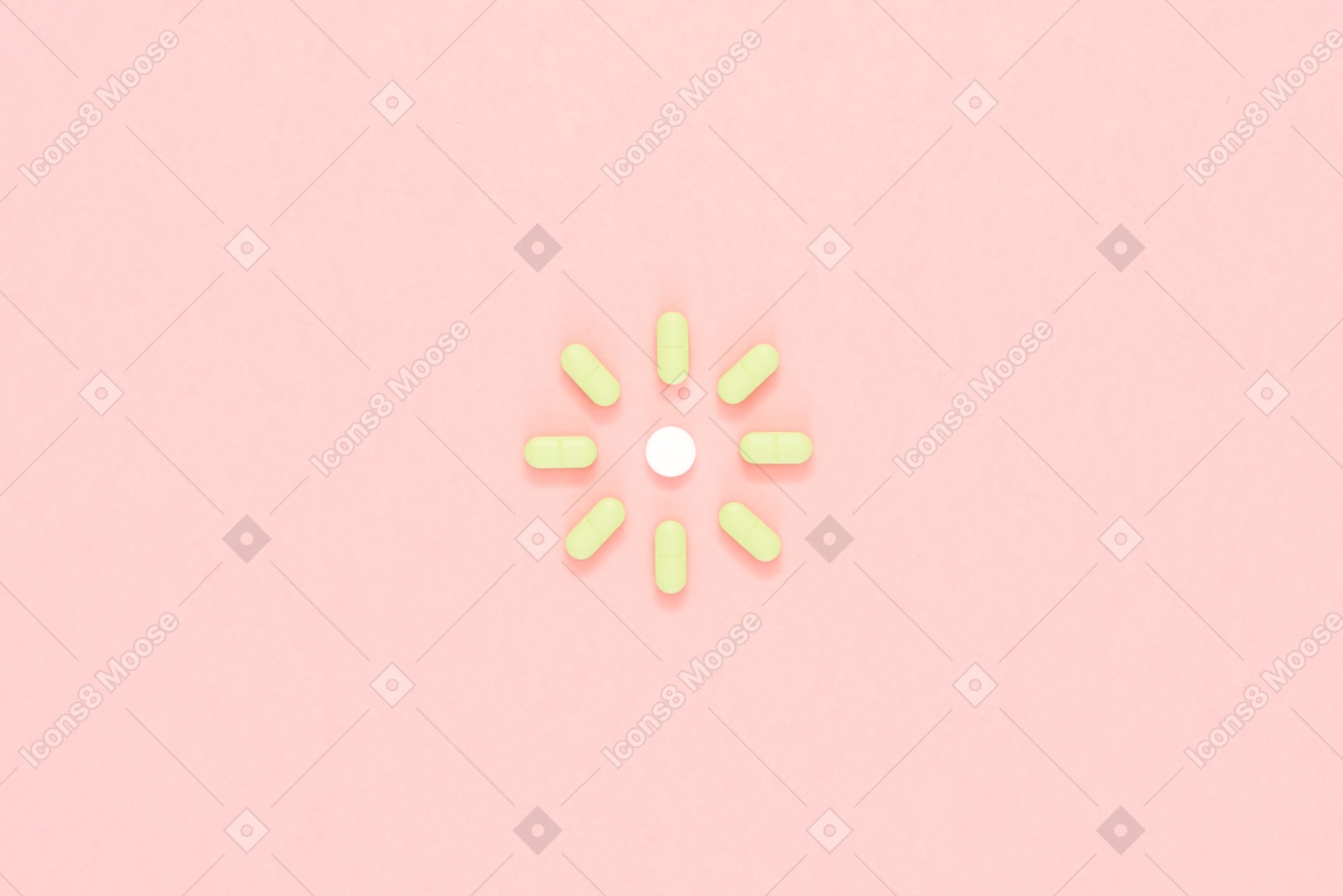 Green pills arranged in a shape of sun