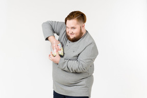 Big bearded man trying to reach marshmallows from the jar