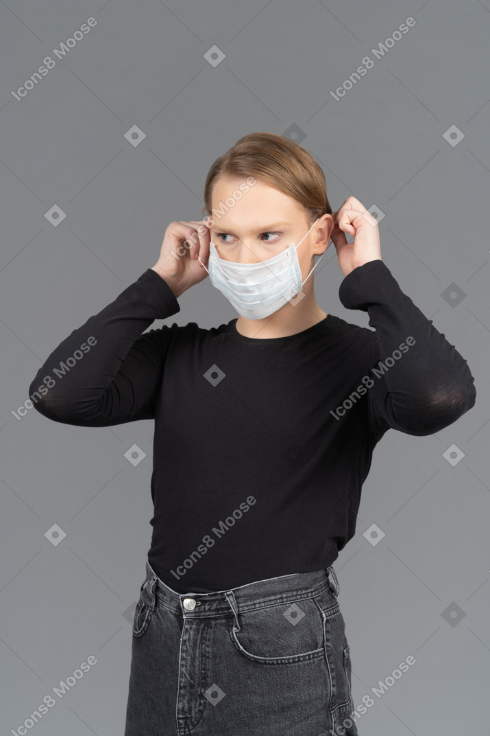 Person putting on medical mask
