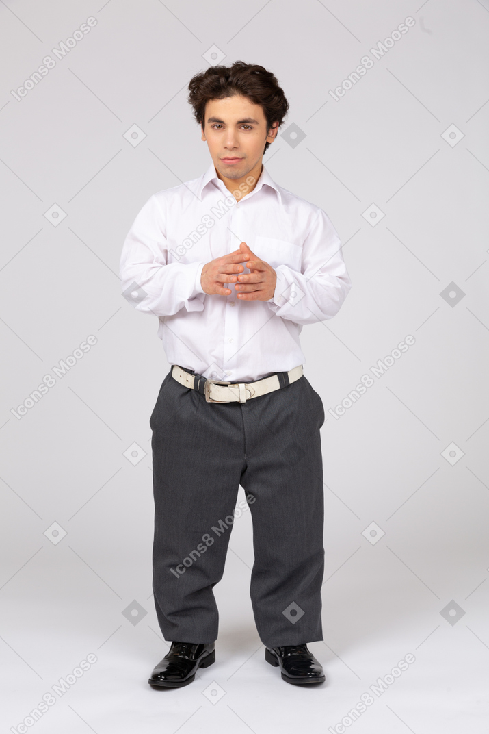Young man with folded hands looing at camera