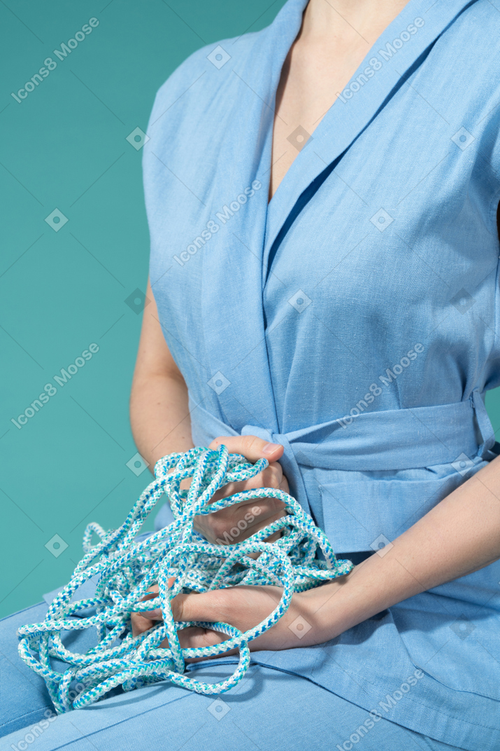 A female holding a blue rope