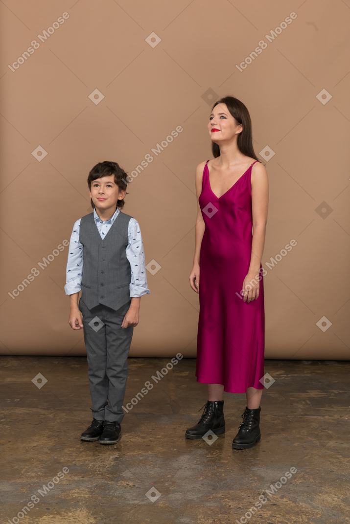 Boy and woman standing still