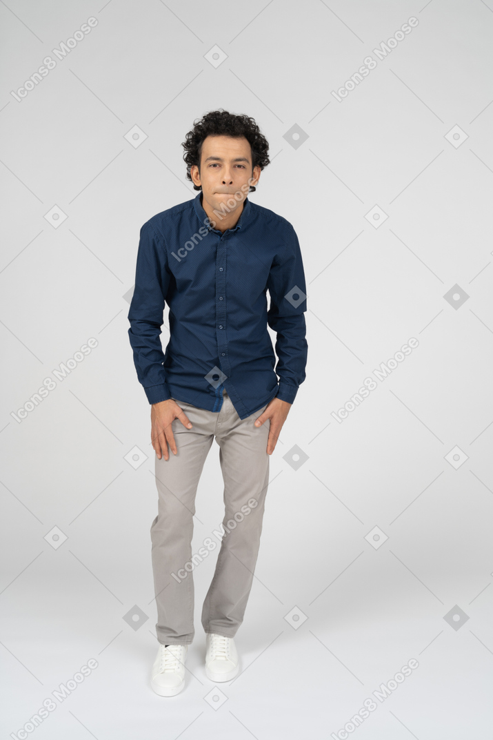 Front view of a man in casual clothes making faces