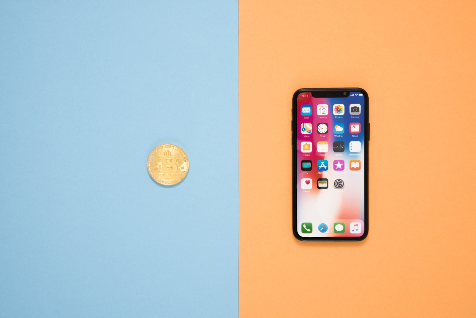 Smartphone and bitcoin over contrast background