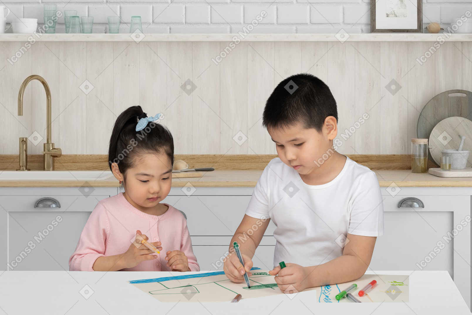 Little boy drawing a picture in the kitchen at home