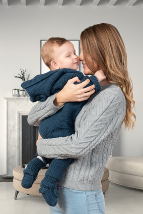 A woman holding a baby in her arms