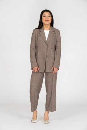 Front view of a pouting young lady in brown business suit