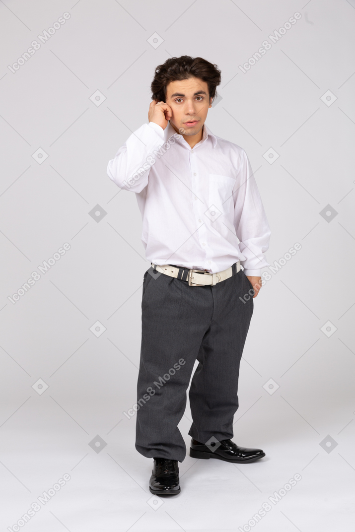 Young office worker touching his ear