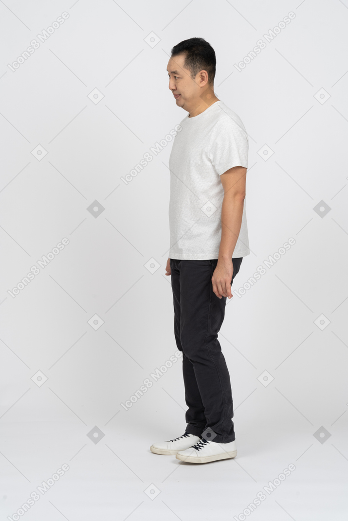 Side view of a man in casual clothes looking at something with disapproval