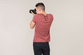 Young guy taking photos with a camera