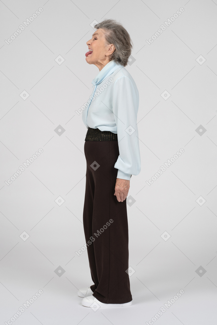 Side view of an old woman mocking childishly