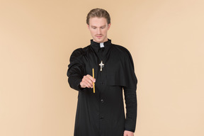 Catholic priest holding candle
