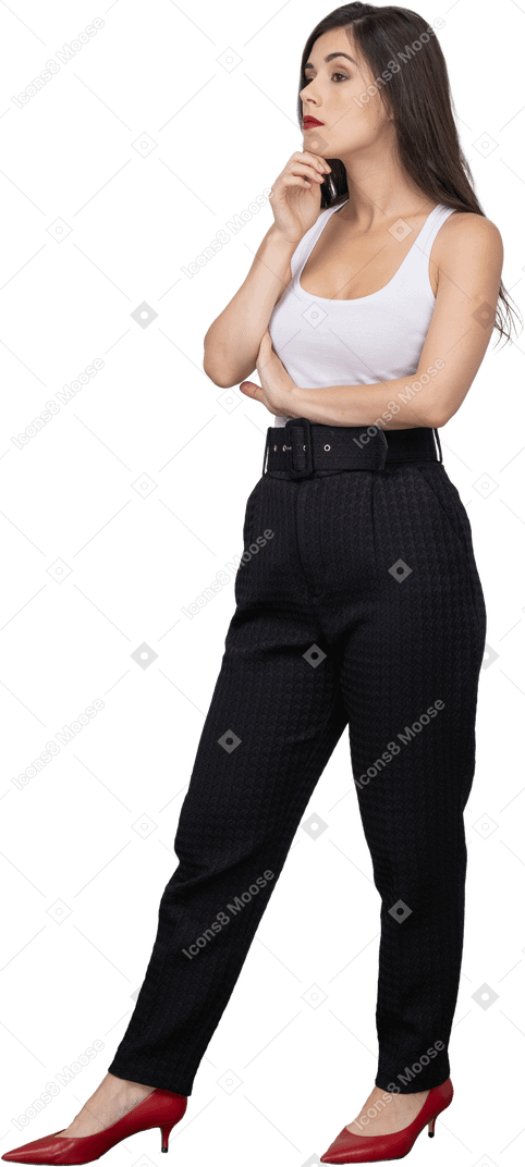 Three-quarter view of a young female in office clothing looking thoughtfully aside