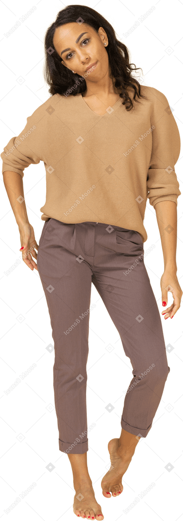 Front view of a dark-skinned female in casual clothes putting hand on hip