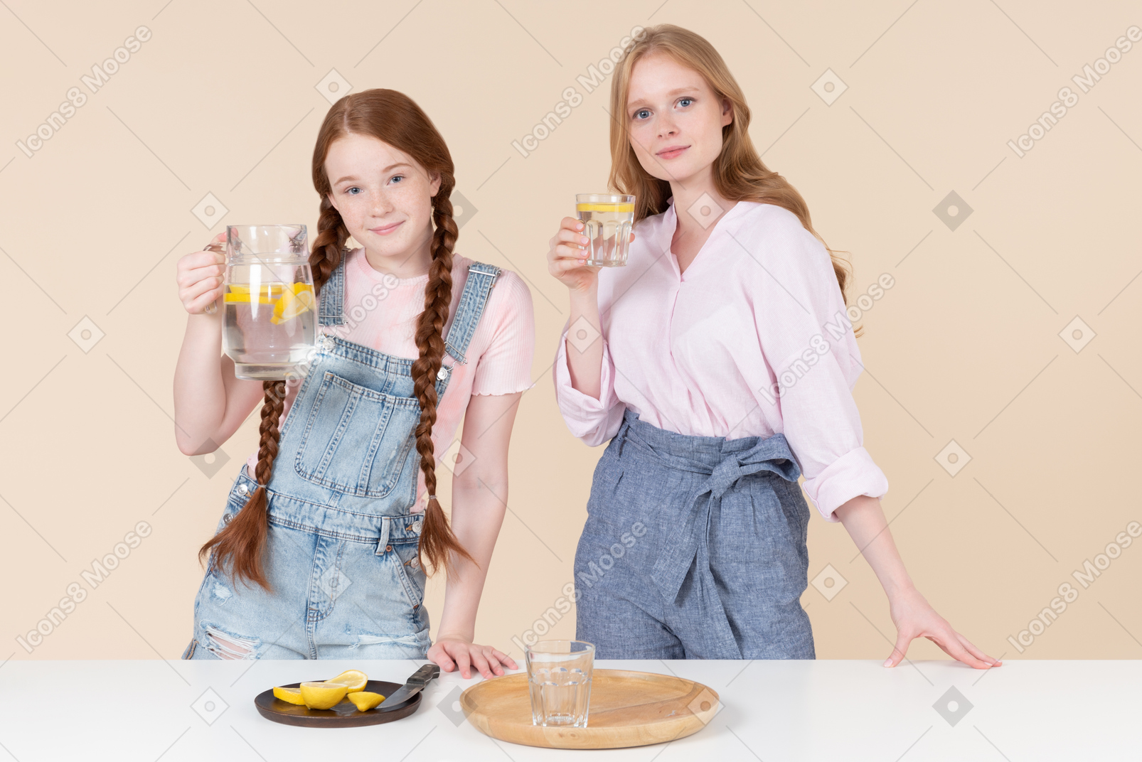 Two young girls holding lemon water