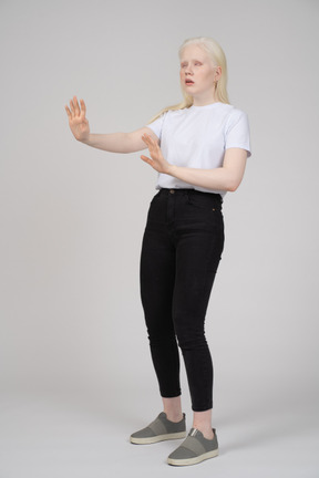 Three-quarter view of a young girl showing off her hands