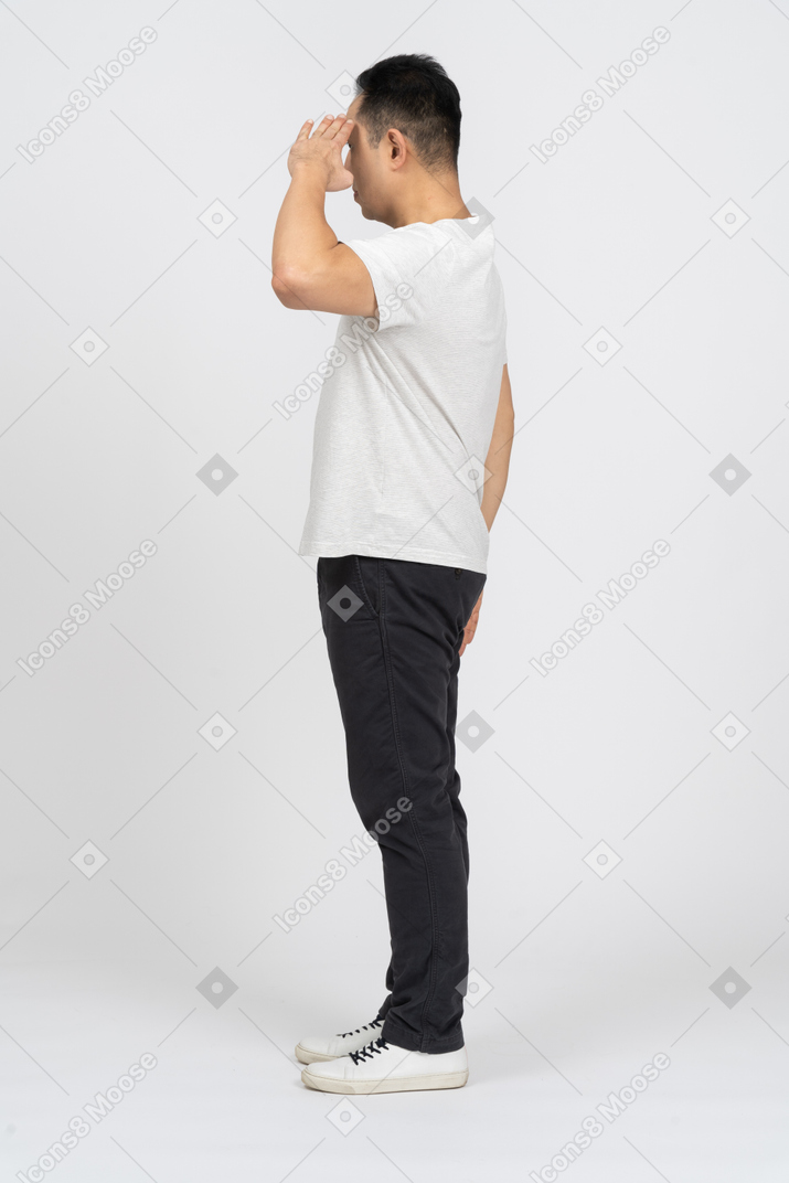 Side view of a man in casual clothes saluting with hand