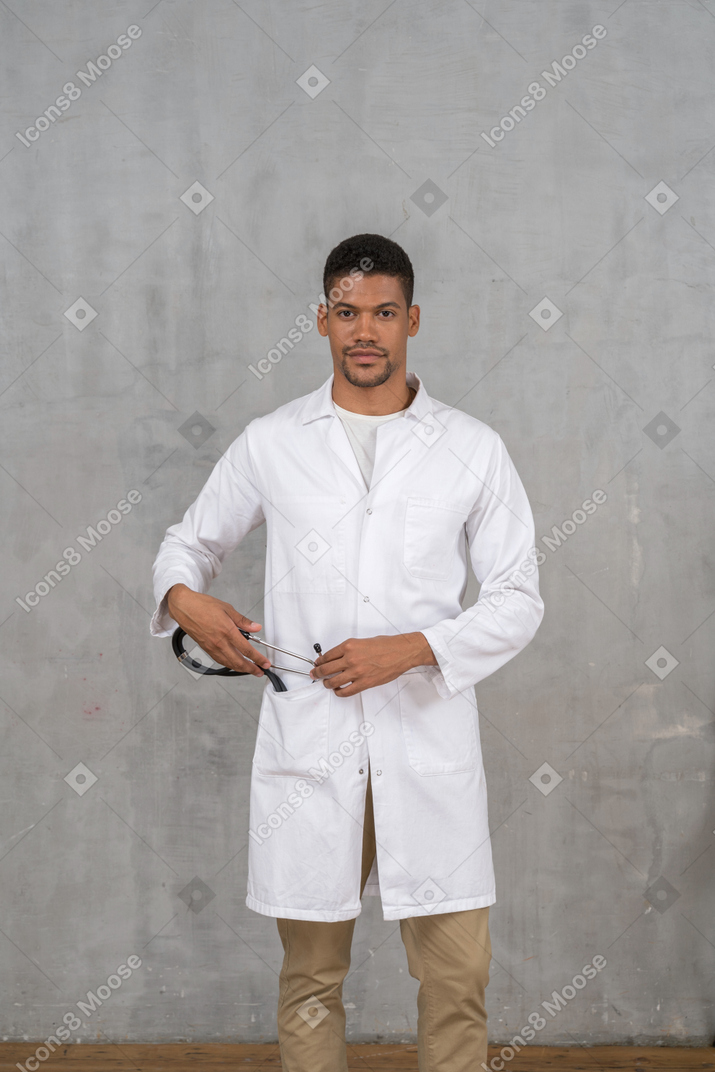 Médico masculino puxando seu estetoscópio para fora