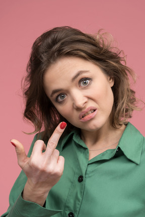 Expressive young woman making a rude gesture