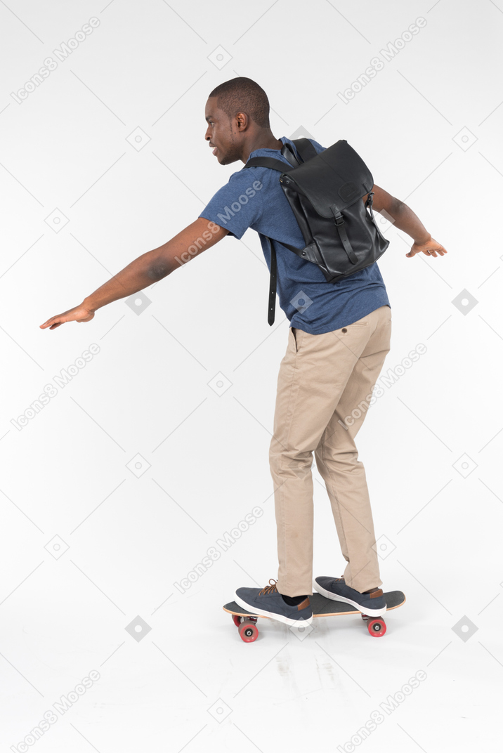 City male tourist standing on skateboard