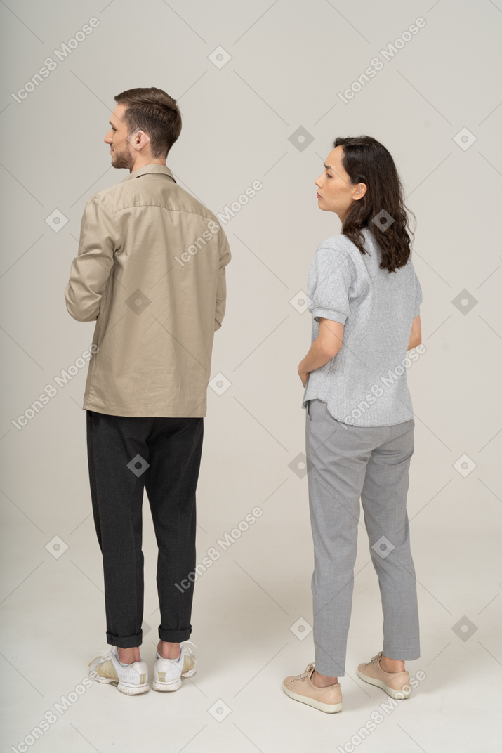 Three-quarter back view of young couple being squeamish