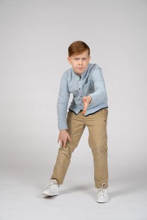 A young boy is posing for a picture