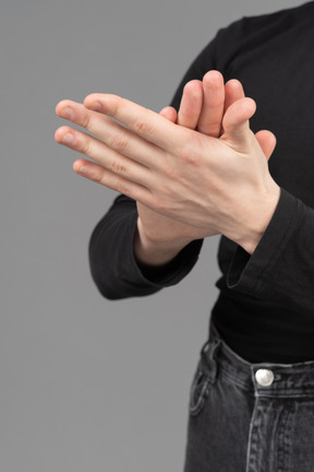 Close-up view of hands rubbing each other