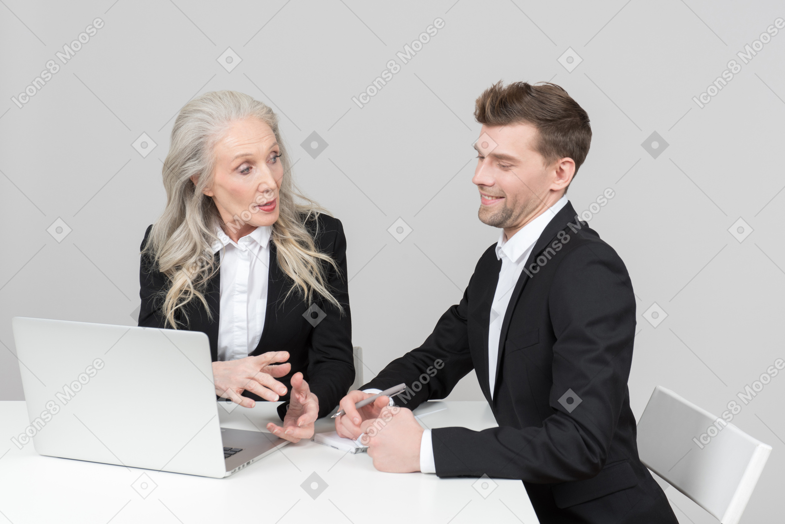 An older woman and a young man working together
