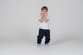 Little child standing with his thumbs in his mouth