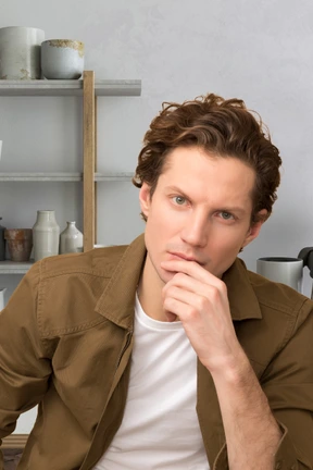 A man wearing a tan jacket
