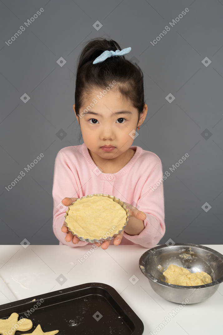 Little girl learning to bake cookies