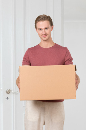 Man holding a cardboard box in front of him