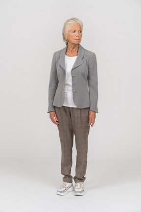 Front view of a sad old woman in suit