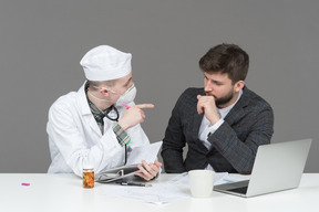 Doctor examining young man in a suit