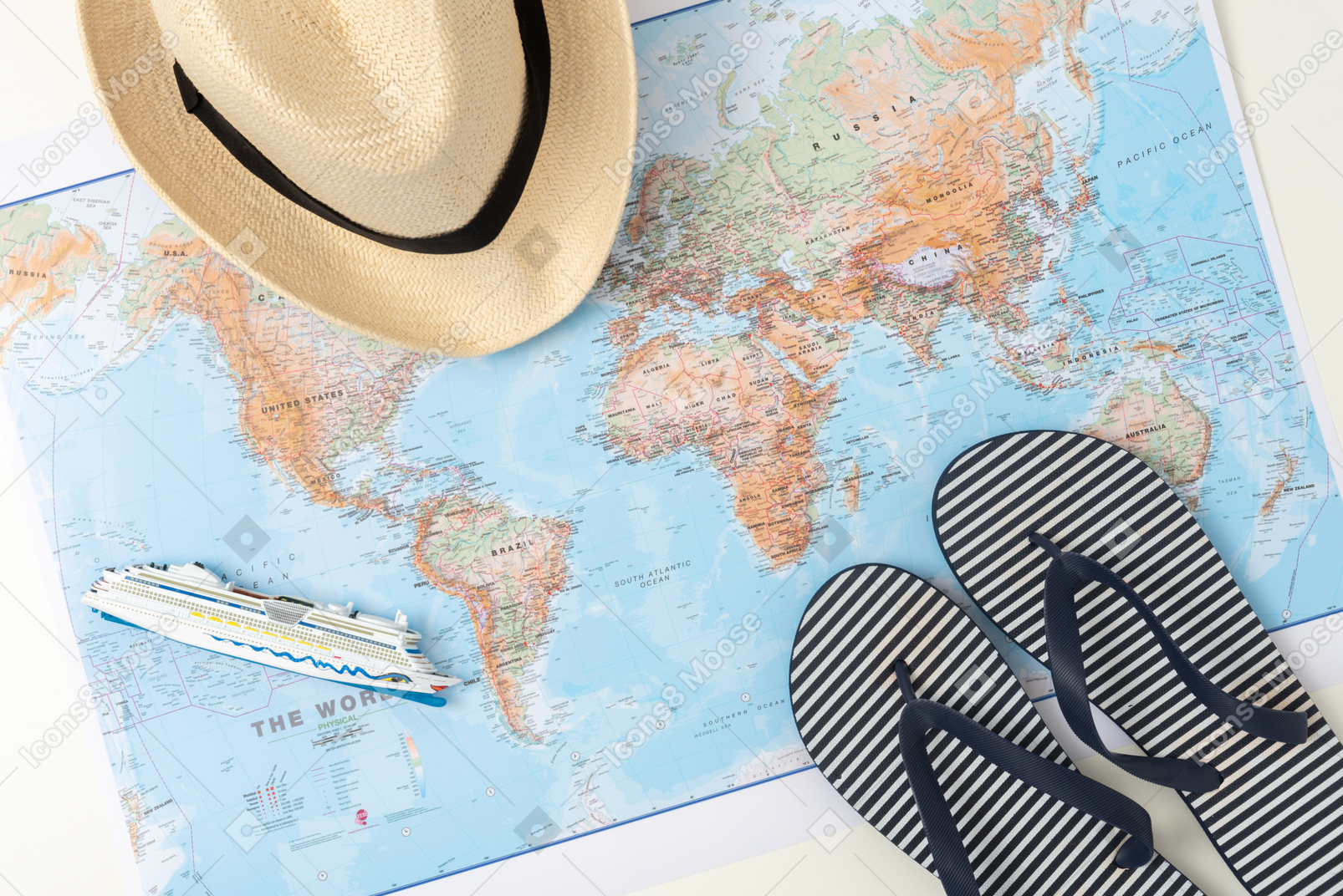 A straw hat, a map and flip-flops, aka every summer tourist's starter pack