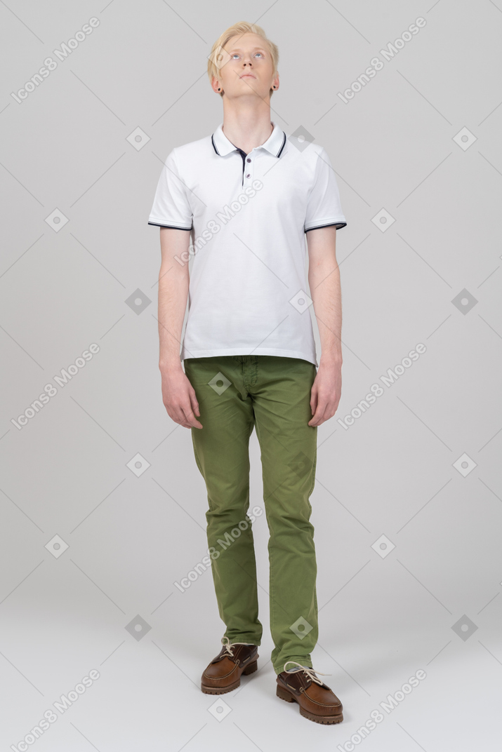 Young man standing and looking up