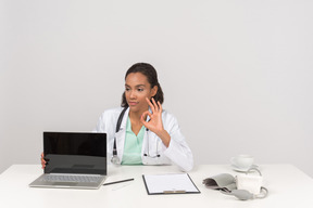 Female doctor showing ok gesture