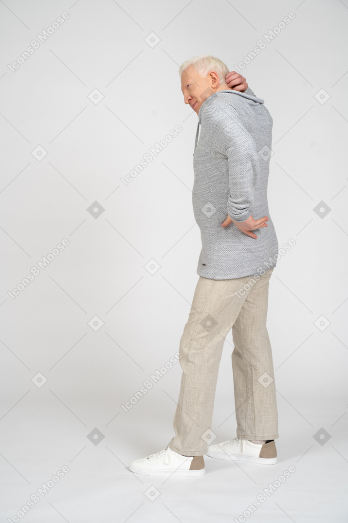 Man standing and scratching the back of his head