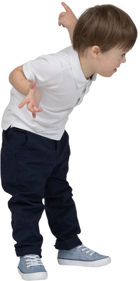 Three-quarter view of a boy leaning forward and pointing behind his back quizzically