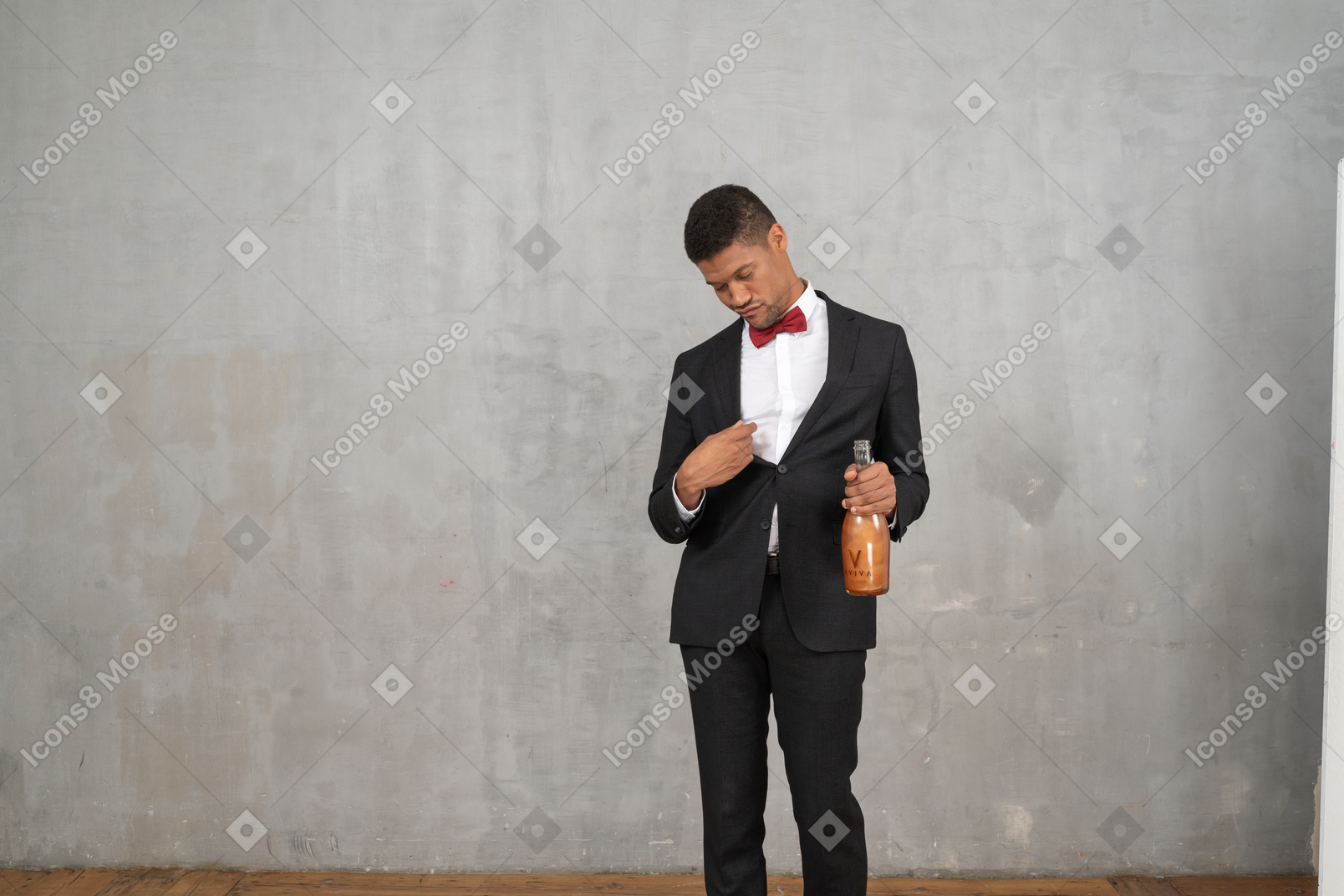 Tipsy man in formal wear standing with a champagne bottle