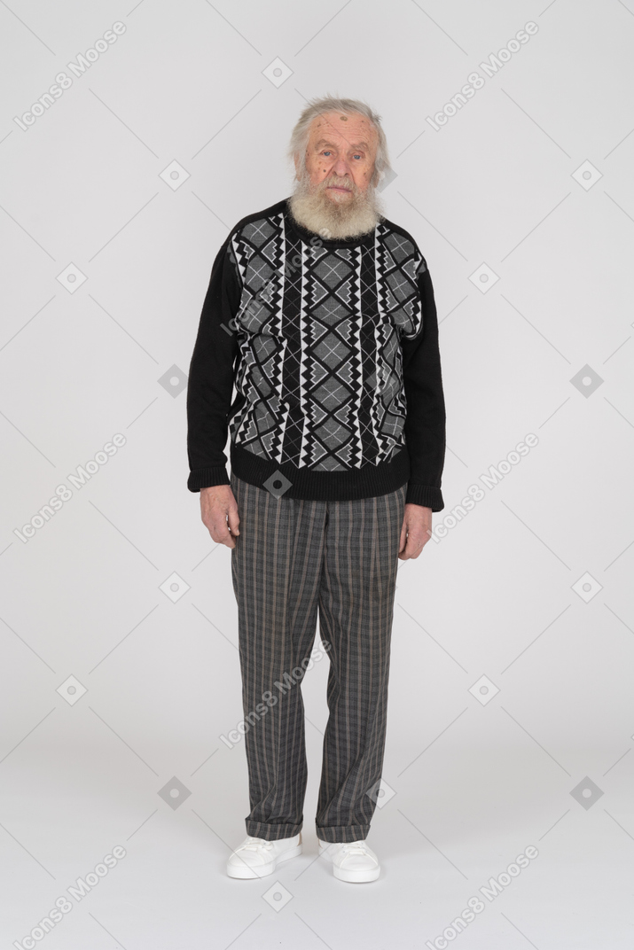 Old man standing and looking at camera