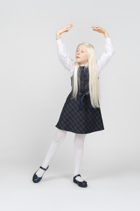 Schoolgirl practicing ballet moves