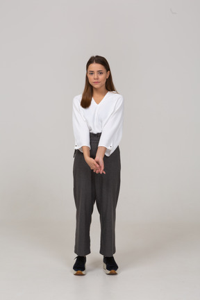 Front view of a young lady in office clothing holding hands together